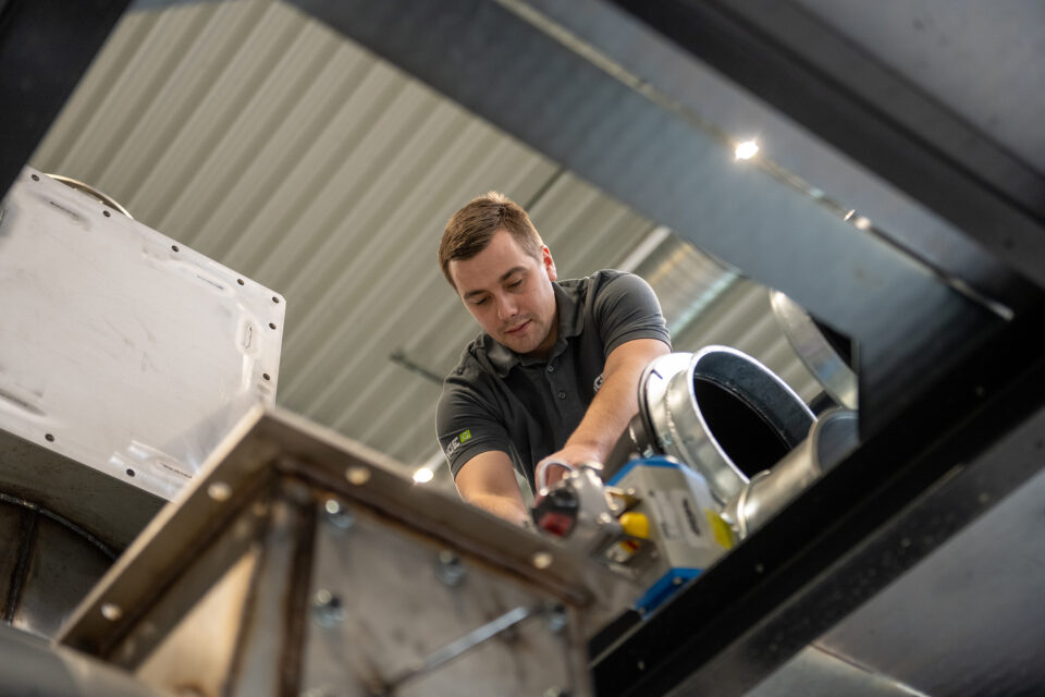 Men working on NGE machine