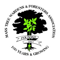 Two men stand on a construction site holding a large blueprint with technical drawings and a visual rendering of a planned building.